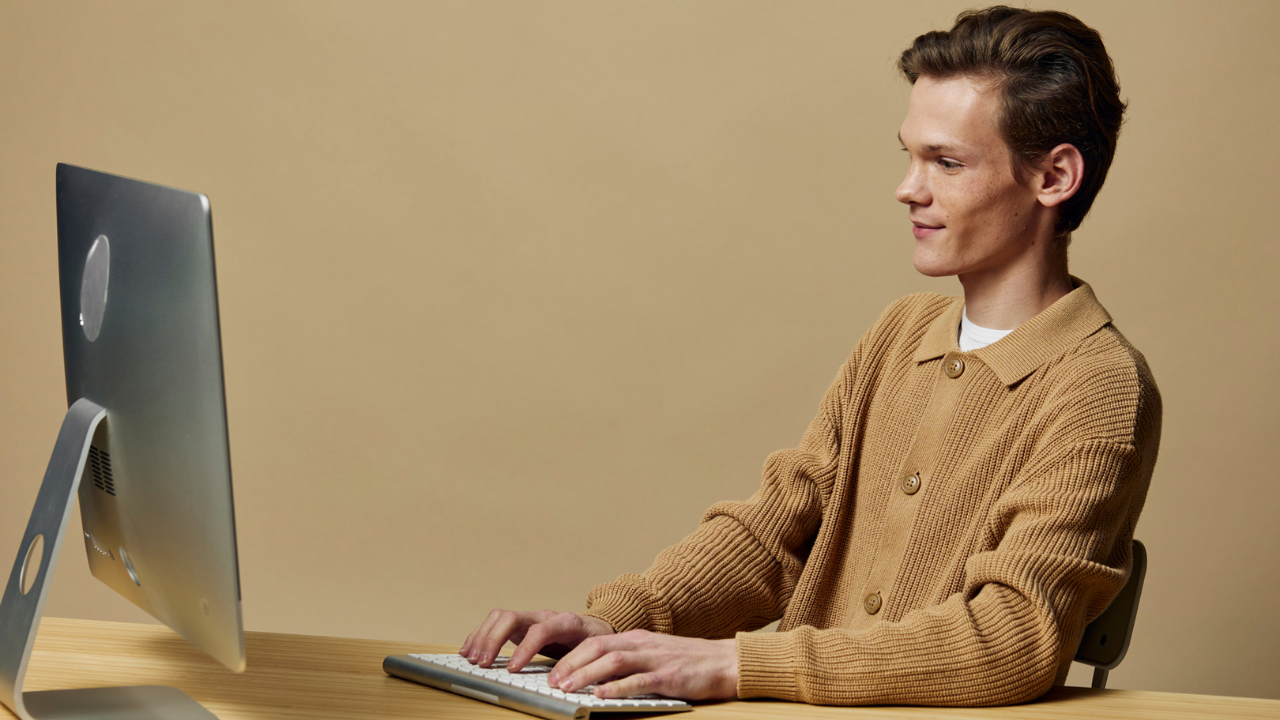 A student looking at computer screen and typing