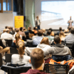 people speaking to an audience at a higher education tech conference