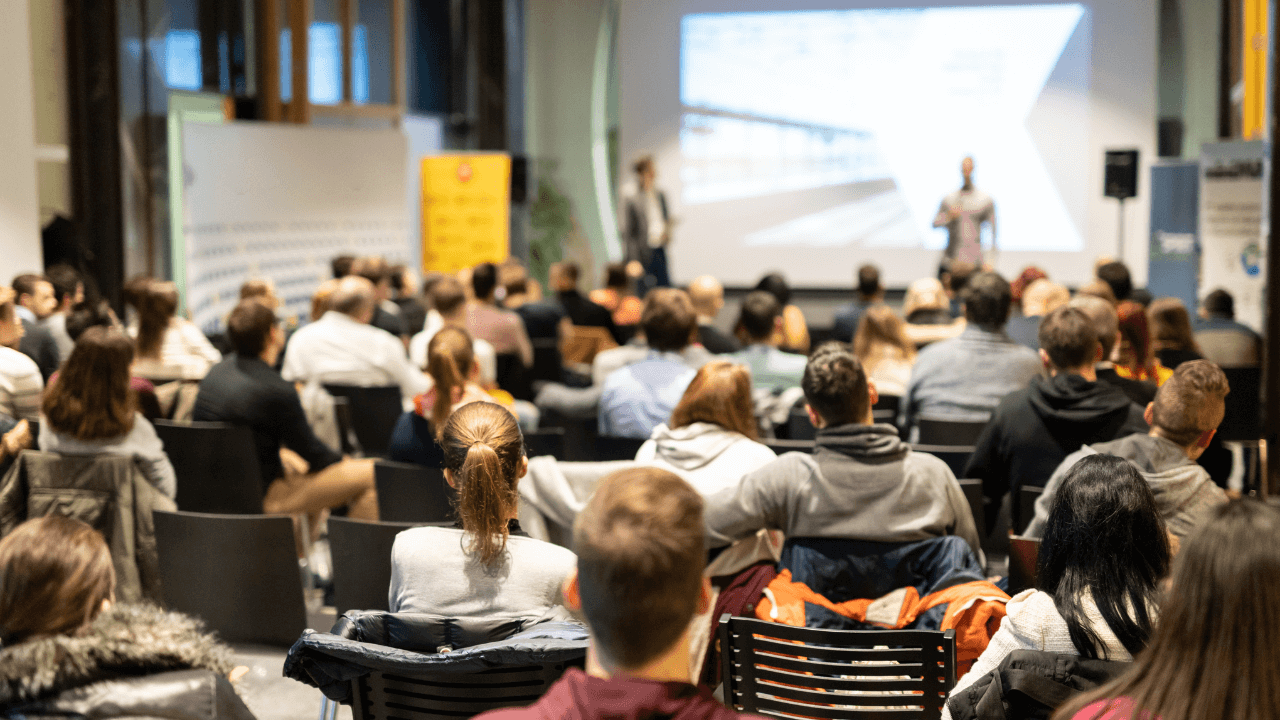 people speaking to an audience at a higher education tech conference