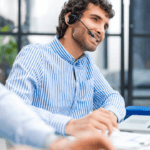 A man in an office with a headset on