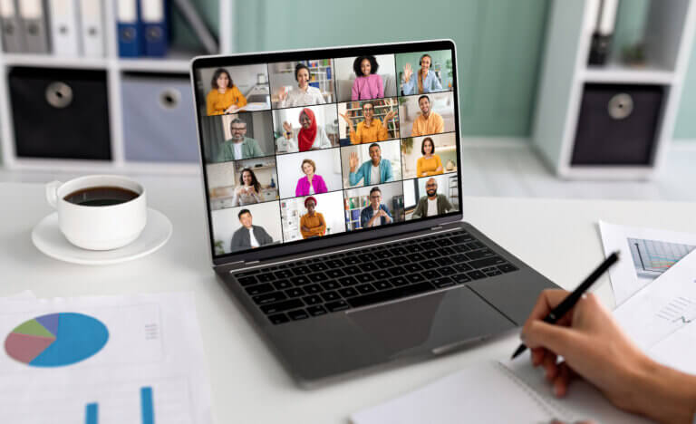 a laptop showing webinar attendees.